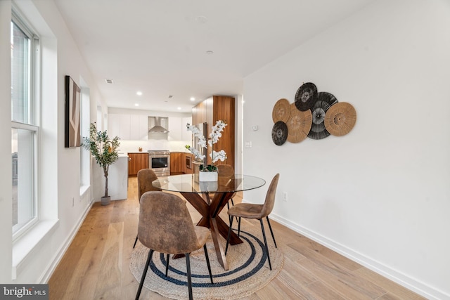 dining area with light hardwood / wood-style floors