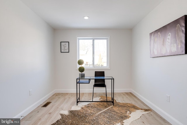 office with light hardwood / wood-style floors