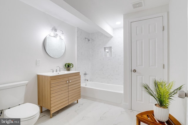 full bathroom featuring tiled shower / bath, vanity, and toilet