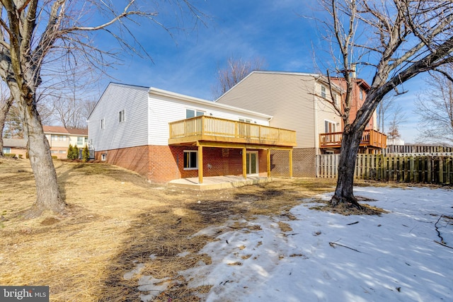 snow covered property featuring a deck