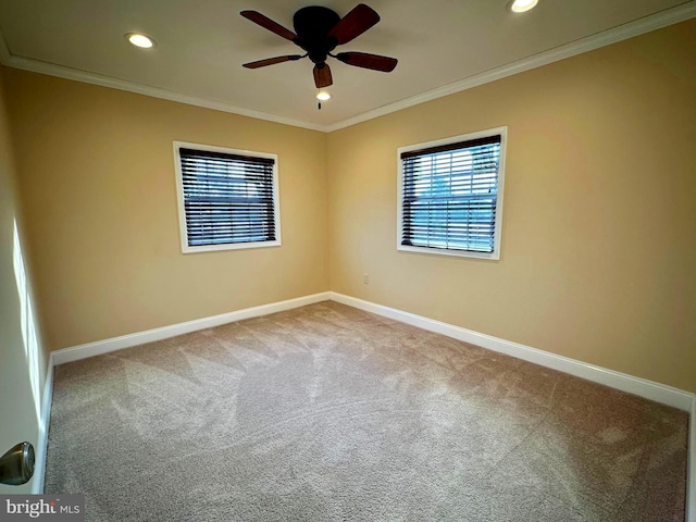 carpeted empty room with ceiling fan and crown molding