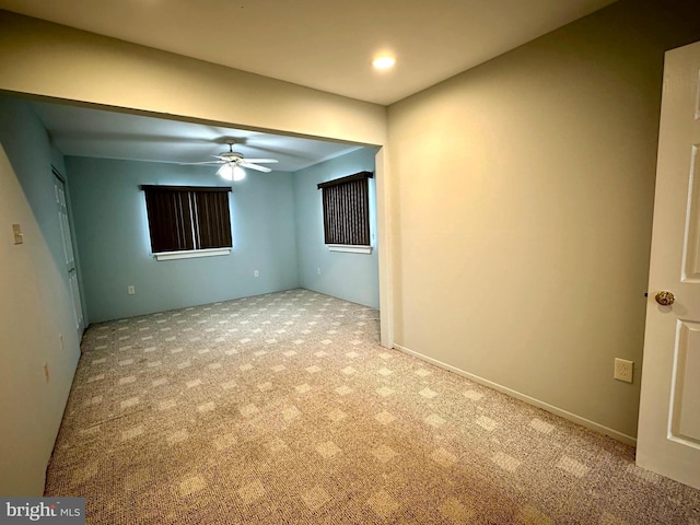 empty room featuring light carpet and ceiling fan