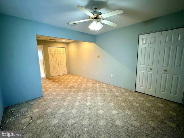 unfurnished bedroom featuring ceiling fan and carpet