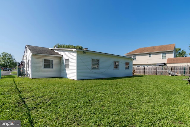 back of property featuring a yard