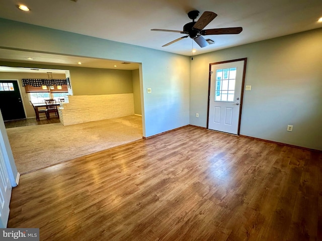 empty room with ceiling fan and wood-type flooring