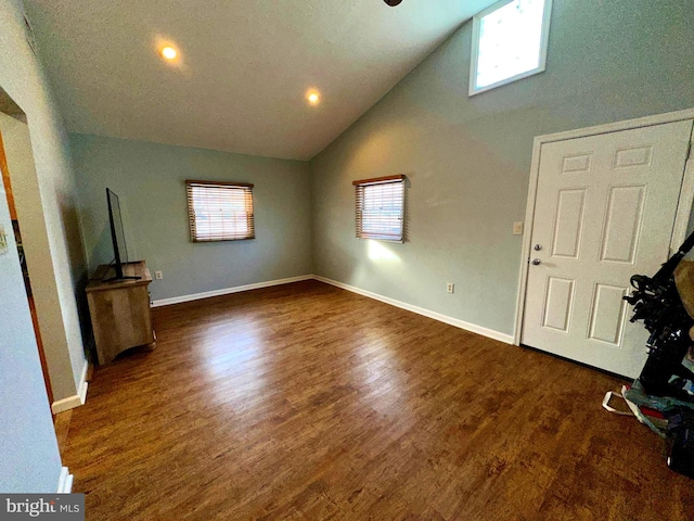 entrance foyer featuring dark hardwood / wood-style floors and vaulted ceiling