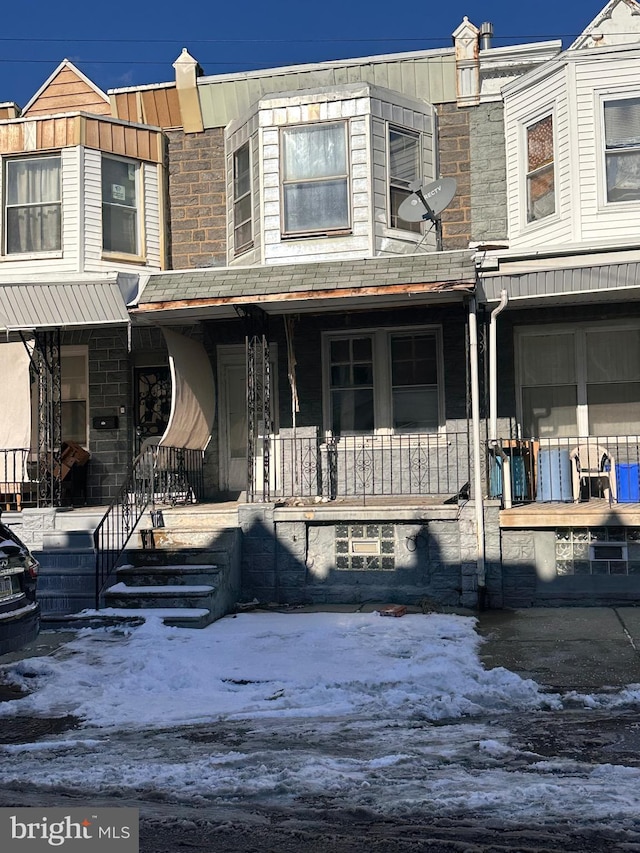 townhome / multi-family property featuring a porch