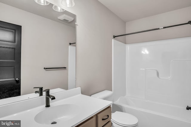 full bathroom featuring toilet, vanity, and shower / washtub combination