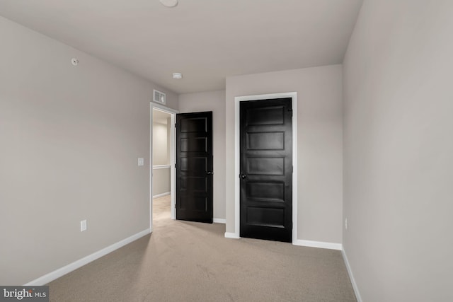 unfurnished bedroom featuring light colored carpet