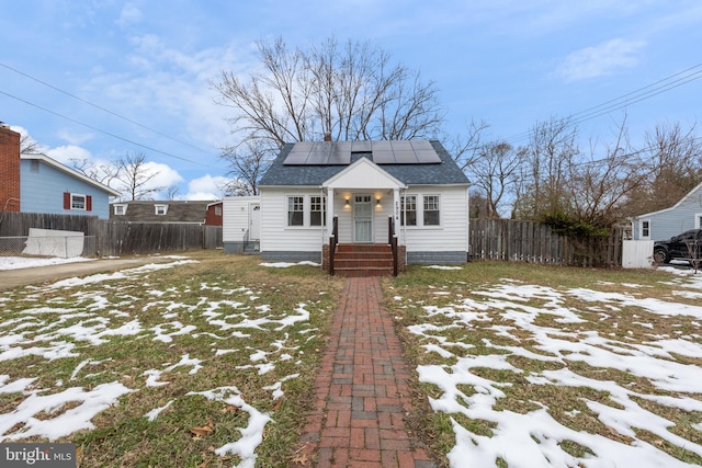 bungalow-style home featuring solar panels