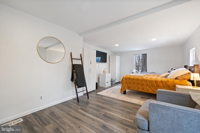 bedroom with dark hardwood / wood-style floors