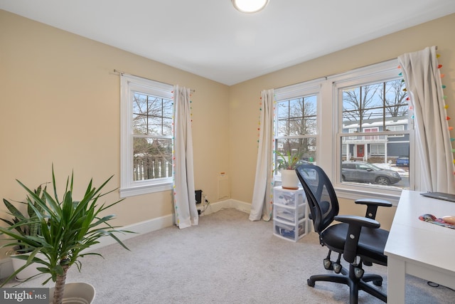 carpeted home office with a healthy amount of sunlight