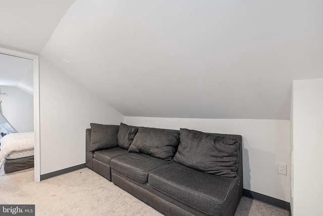 living room with light carpet and vaulted ceiling