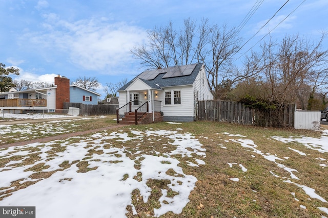 bungalow-style house featuring solar panels