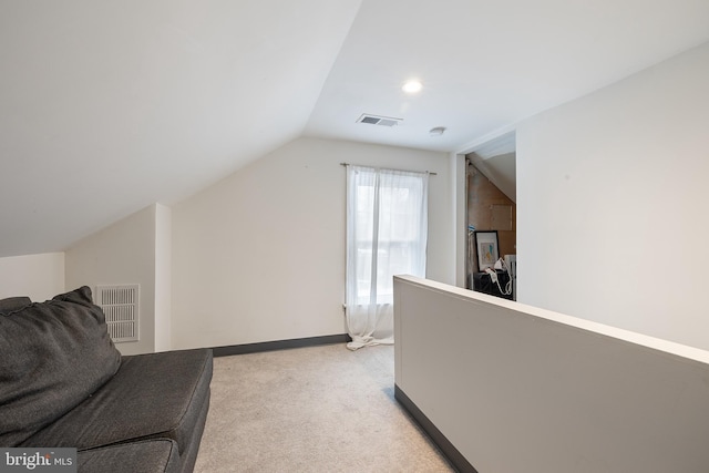 living area featuring lofted ceiling and light colored carpet