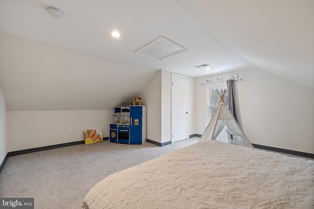 unfurnished bedroom featuring light colored carpet and vaulted ceiling