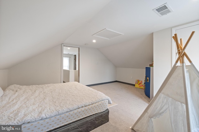 carpeted bedroom with vaulted ceiling