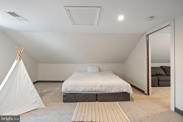 bedroom with light colored carpet and vaulted ceiling