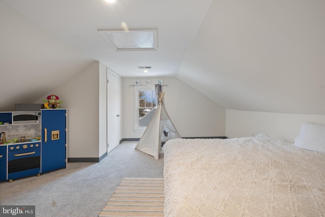 bedroom featuring light carpet and vaulted ceiling