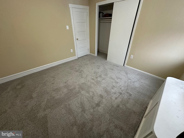 unfurnished bedroom with carpet floors and a closet