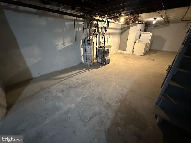 basement featuring gas water heater and washer / clothes dryer