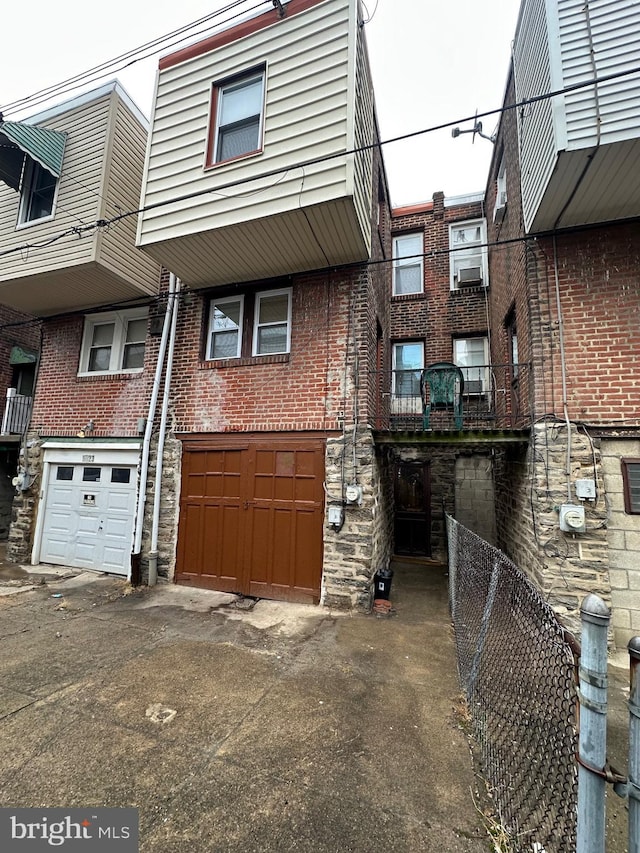 rear view of property featuring a garage