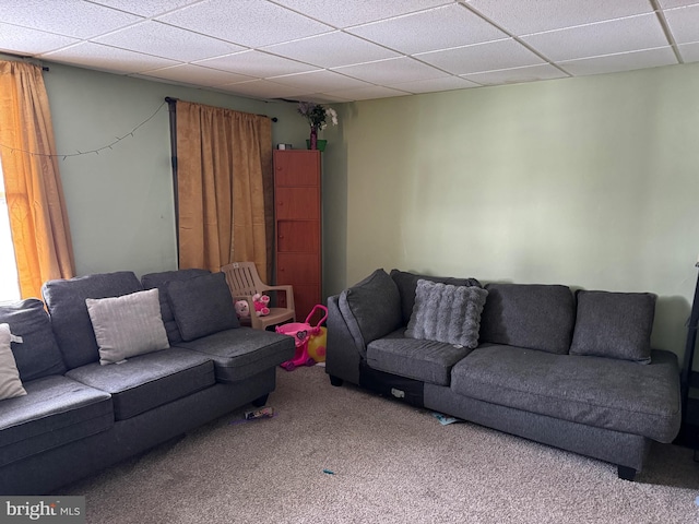 living room with carpet and a paneled ceiling