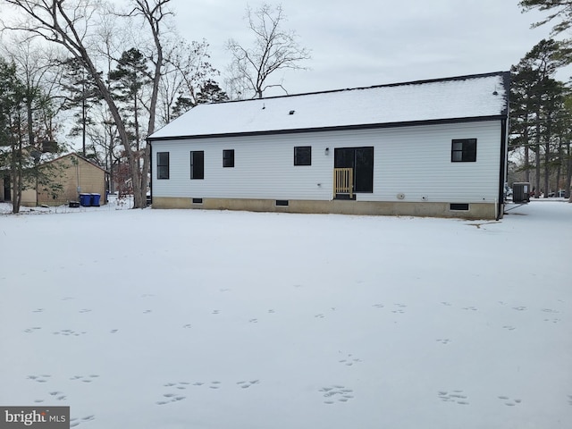 snow covered property featuring central AC unit