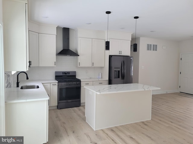 kitchen with a sink, visible vents, refrigerator with ice dispenser, wall chimney range hood, and gas stove