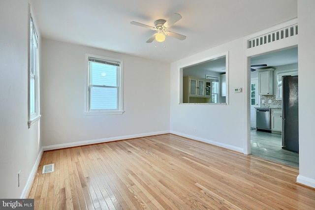 spare room with light hardwood / wood-style floors and ceiling fan