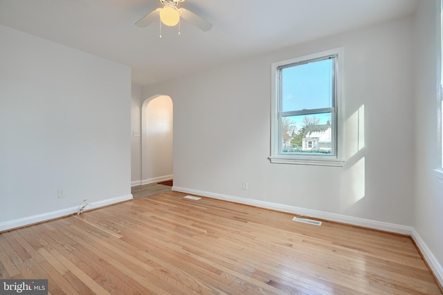 empty room with light wood-type flooring and ceiling fan