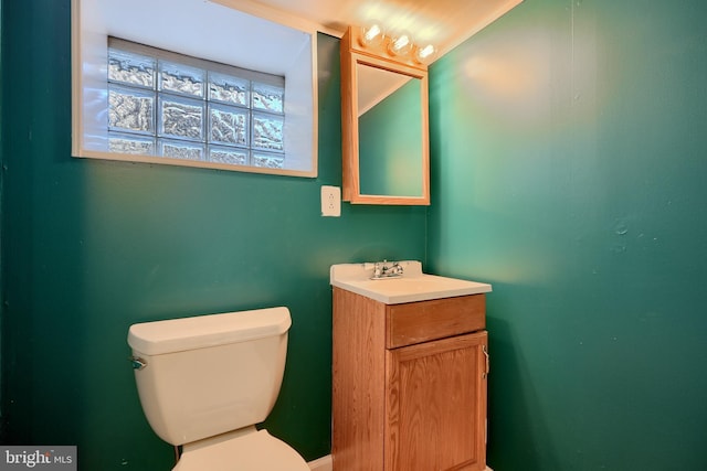 bathroom featuring toilet and vanity