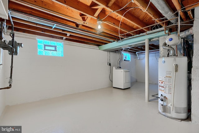 basement with water heater and washer / dryer