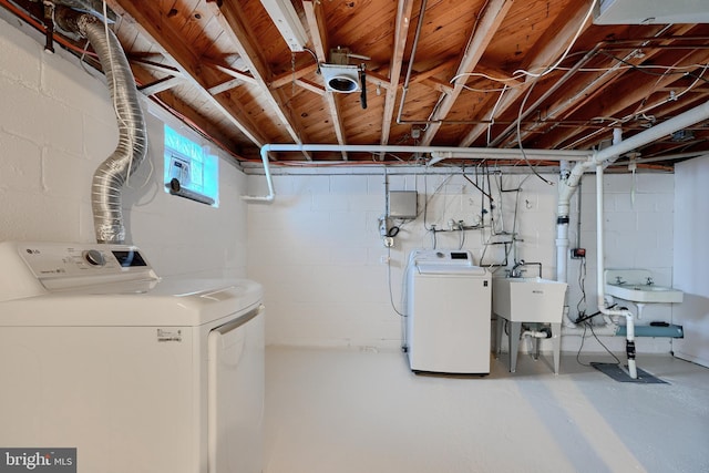 clothes washing area with sink and independent washer and dryer