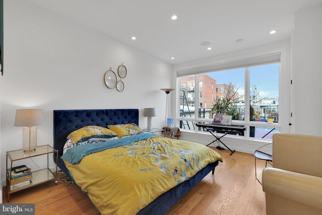 bedroom featuring multiple windows and light hardwood / wood-style flooring