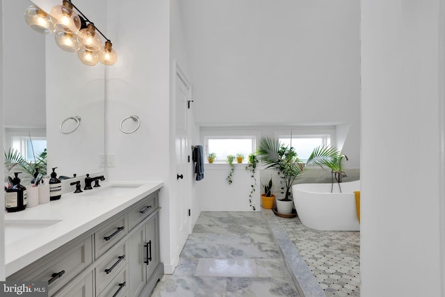 bathroom featuring a tub to relax in and vanity