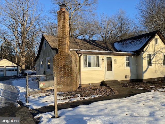 view of front facade with a garage and an outdoor structure