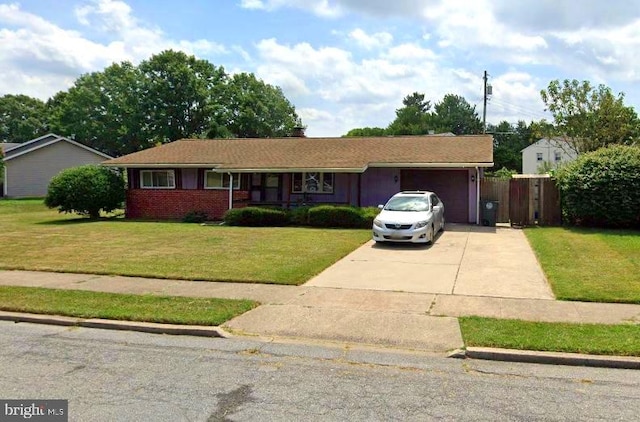 ranch-style house with a garage, brick siding, driveway, and a front lawn