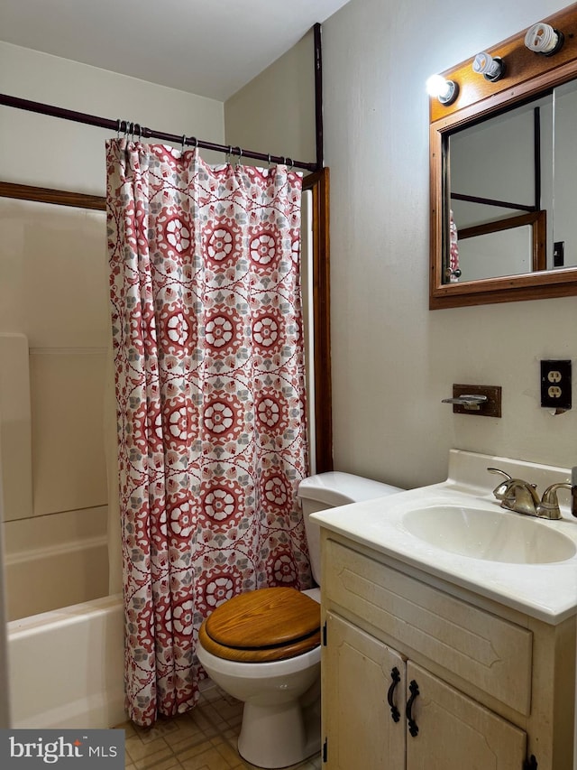 full bathroom featuring toilet, shower / tub combo with curtain, and vanity