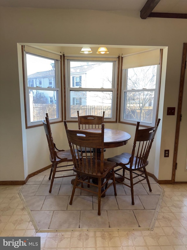 dining room with light floors and baseboards