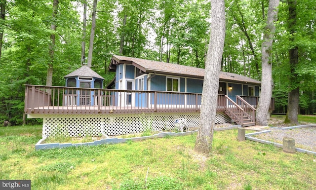 back of house featuring a yard, a gazebo, and a deck