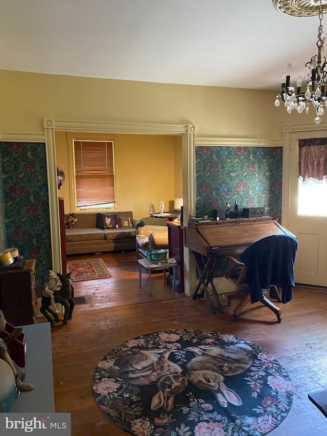 dining space with hardwood / wood-style flooring and a notable chandelier