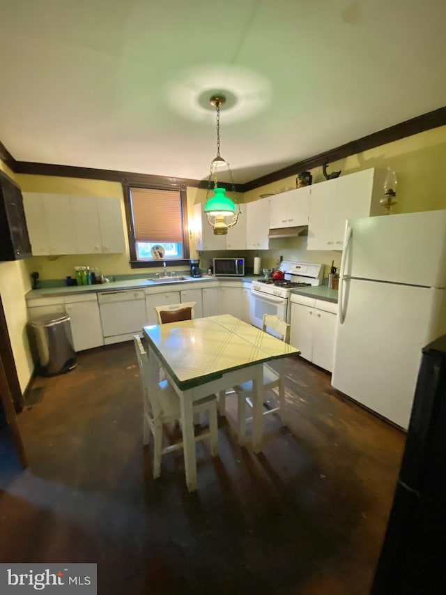 kitchen with white appliances, white cabinetry, sink, hanging light fixtures, and crown molding