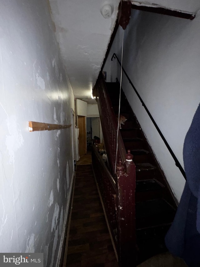 stairs featuring hardwood / wood-style floors