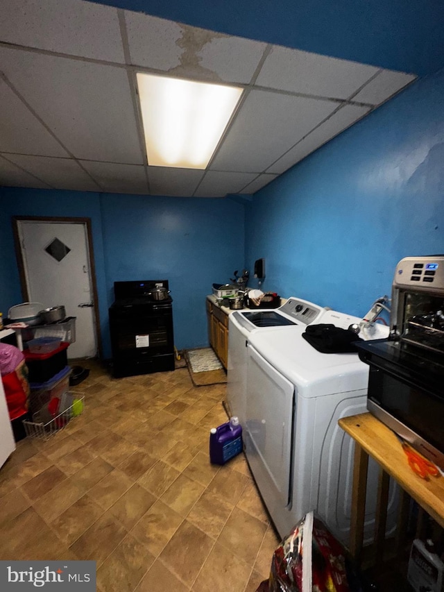 clothes washing area with washing machine and dryer