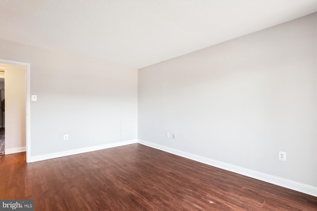 spare room featuring dark hardwood / wood-style floors