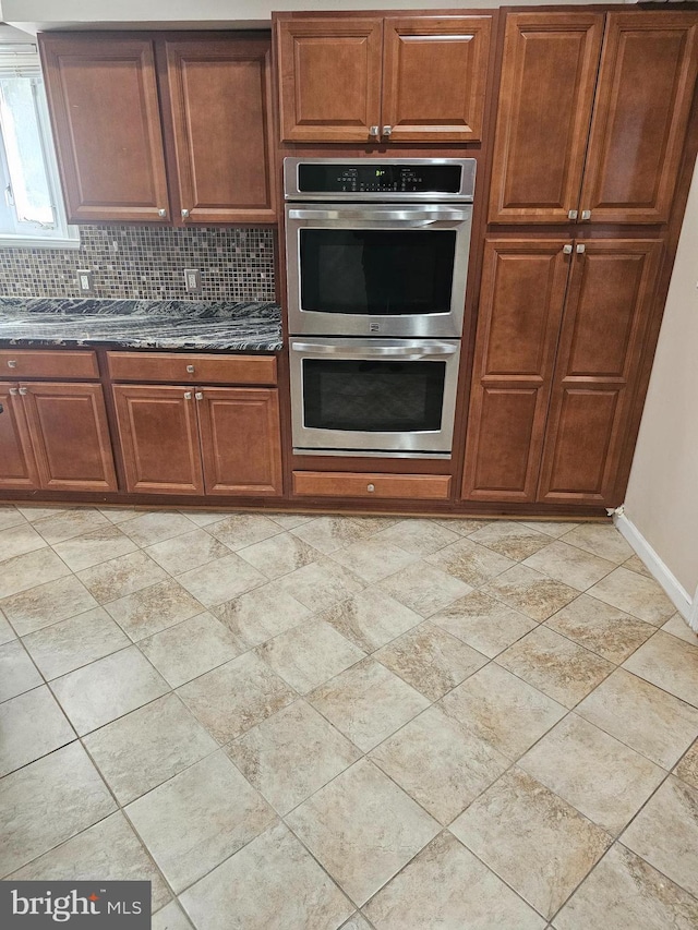 kitchen with backsplash and stainless steel double oven