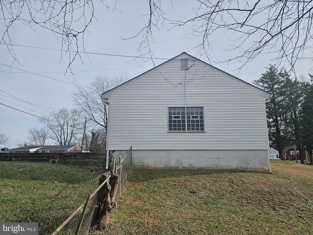 view of side of property with a yard