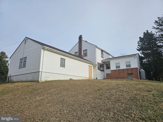 rear view of house featuring a yard