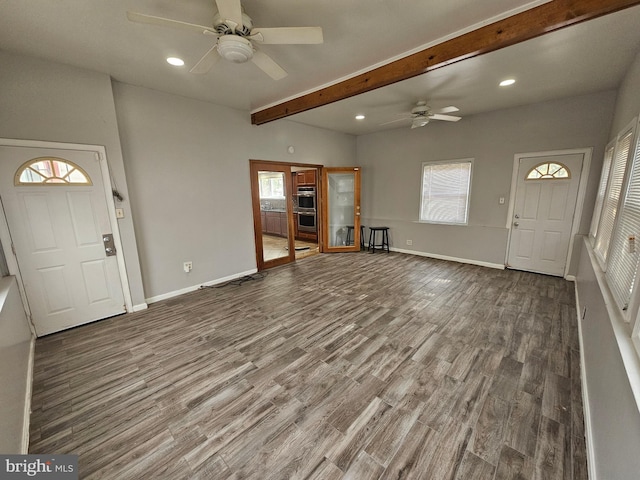 unfurnished living room with hardwood / wood-style flooring, beamed ceiling, and ceiling fan